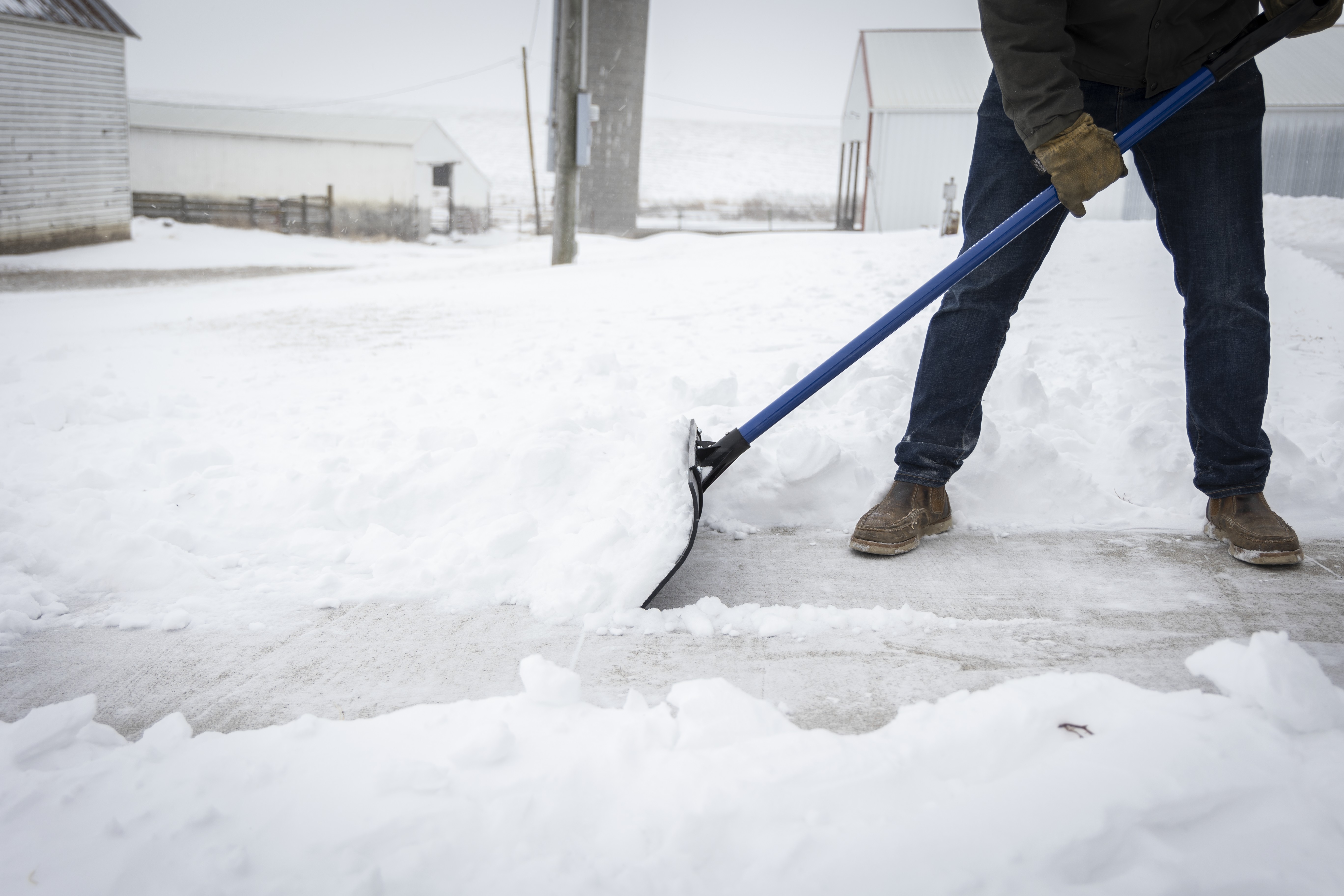 man pushing snow with the polar pusher